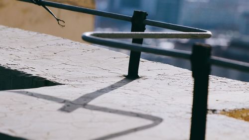 Close-up of railing on footpath