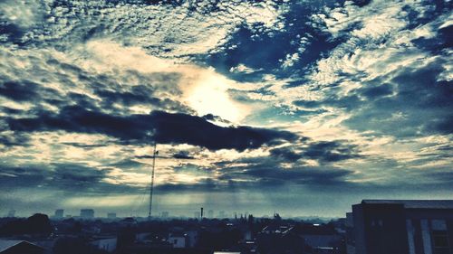 Cloudy sky above city at sunset