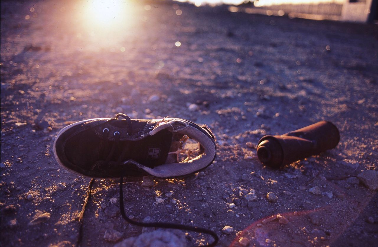 single object, road, close-up, reflection, sun, sunbeam, day, focus on foreground, outdoors, surface level, no people