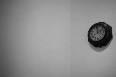 Close-up of clock against wall