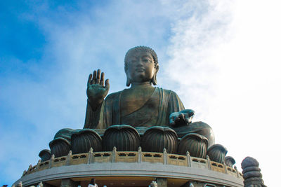 Low angle view of tian tan buddha against sky