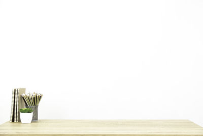 Stack of table against white wall