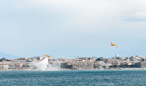 Air vehicles flying over sea against sky