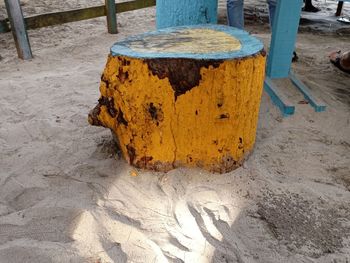 High angle view of yellow container on sand