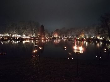 Scenic view of lake against sky at night