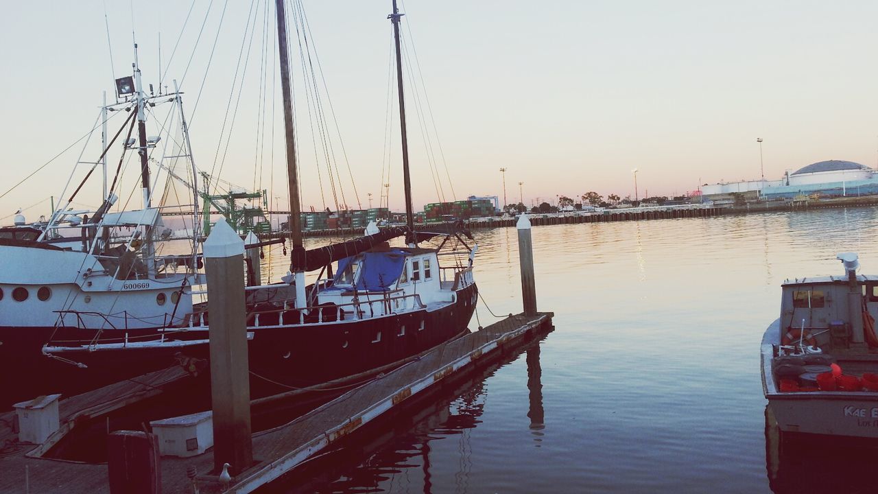 transportation, nautical vessel, mode of transport, water, moored, boat, harbor, river, built structure, clear sky, mast, waterfront, architecture, reflection, sky, travel, outdoors, no people, building exterior, day