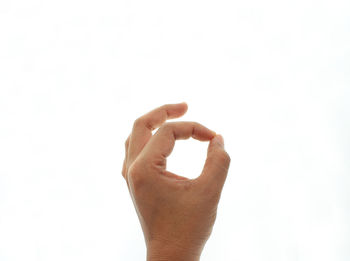 Close-up of human hand against white background