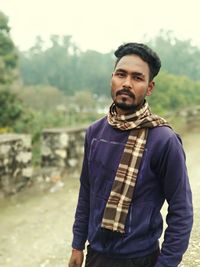 Portrait of young man standing outdoors