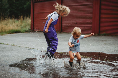 Full length of children on water