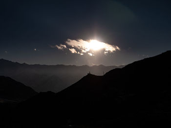 Scenic view of silhouette mountains against sky at sunset