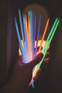 Close-up of hand holding multi colored lights