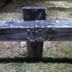Old wooden structure on grassy field