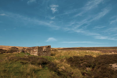 Built structure on field against sky