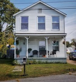 People outside house against building