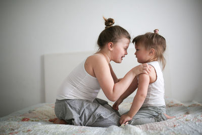 Sister's girls play and hug, emotions. concept childhood and related relationships, lifestyl