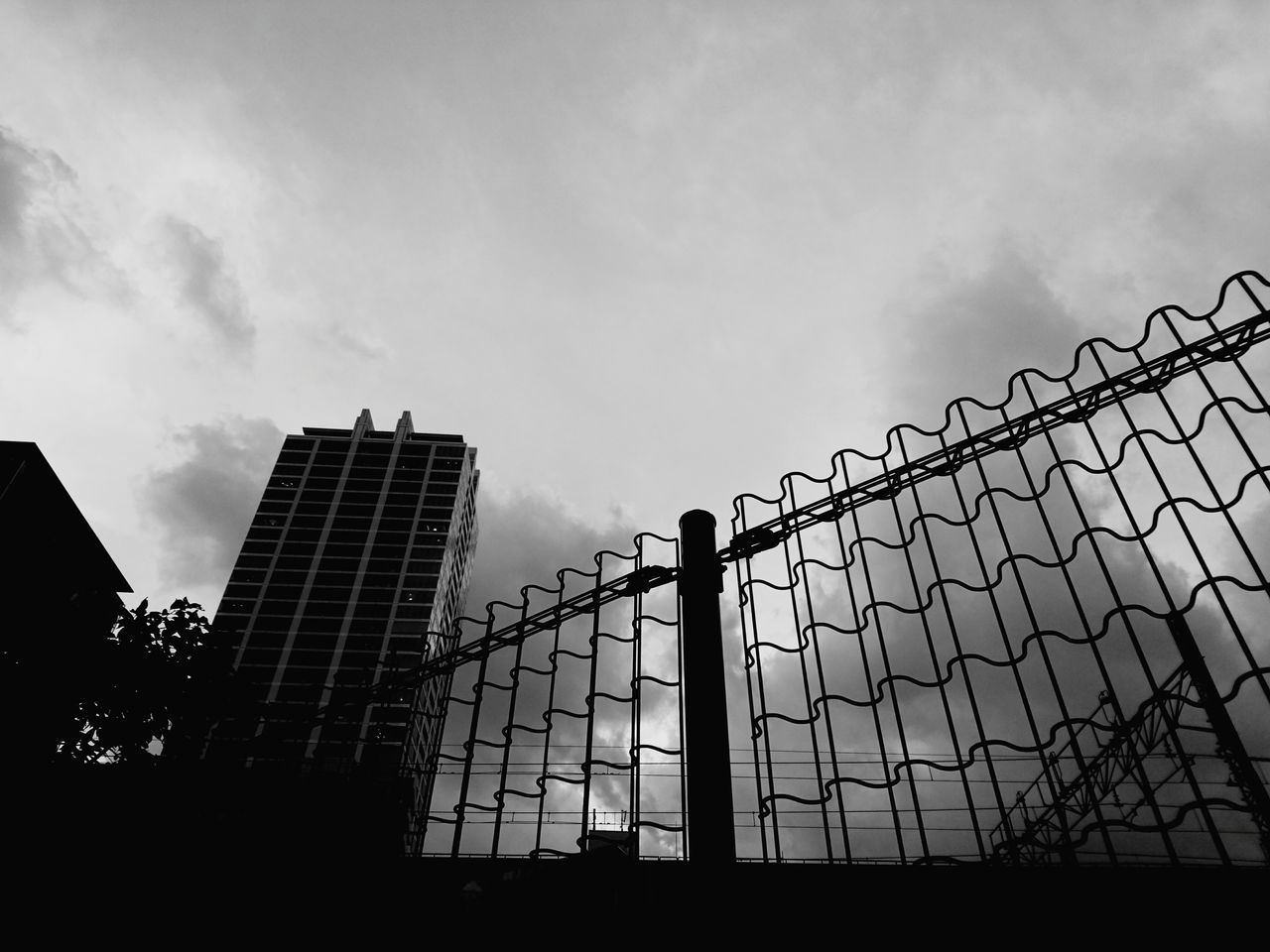 sky, built structure, architecture, protection, building exterior, low angle view, outdoors, cloud - sky, day, modern, no people, city