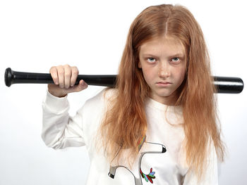 Portrait of a girl holding camera over white background