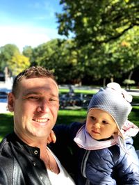 Portrait of father and son outdoors