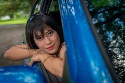 Portrait of smiling woman sitting in car