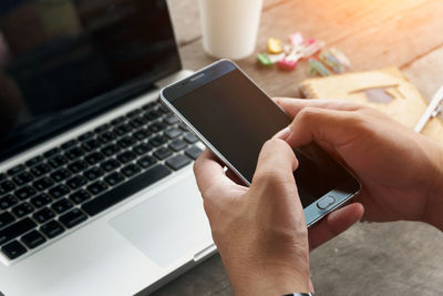 Midsection of man using mobile phone