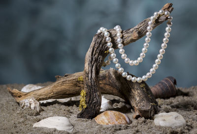 Close-up of pearl necklace on wood