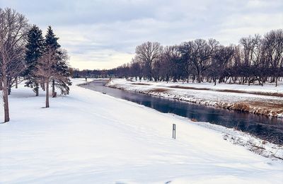 Snow covered landscape against sky