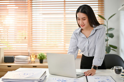 Young woman using laptop at home