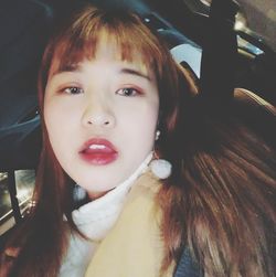 Close-up portrait of woman in car