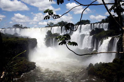 Scenic view of waterfall against sky