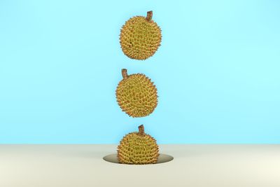 Digital composite image of durian over colored background