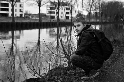 Portrait of young man standing in forest