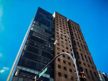 Low angle view of modern building against blue sky