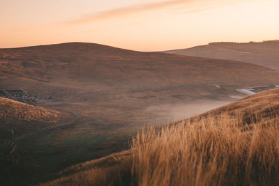 Scenic view of field against sky during sunset