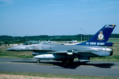 Airplane on airport runway against clear sky