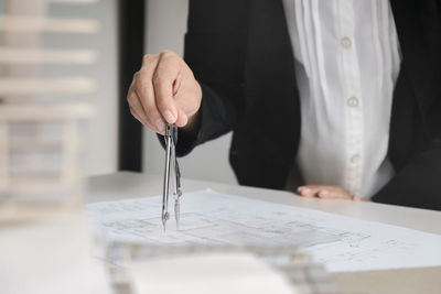 Midsection of man working with umbrella