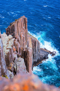 High angle view of rocks on sea shore