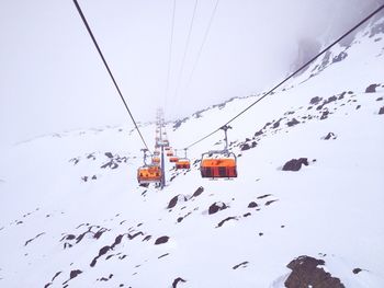 View of ski lifts in snowy valley