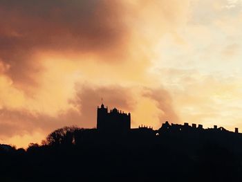 Silhouette of built structure at sunset