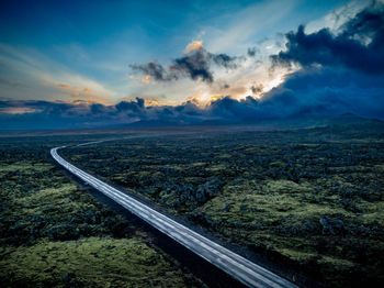 Road travels through icelandic landscape