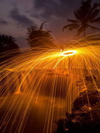 Low angle view of firework display at night