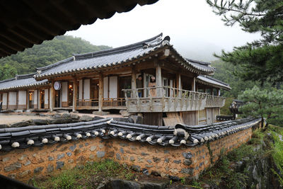 Temple by building against sky