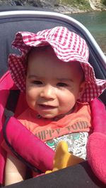 Portrait of cute girl sitting in car
