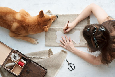 Top view of woman hands making diy dog toy from textile and eco filler 