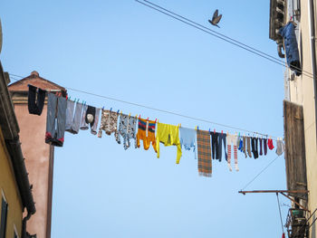 Low angle view of clothes drying against buildings