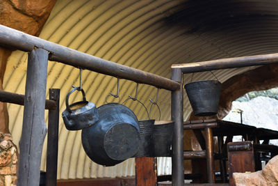 Fire buckets hanging on a handrail by campsite