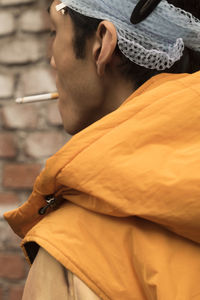 Side view of young woman standing outdoors