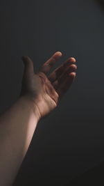 Close-up of person hand against gray background