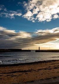 Scenic view of beach against sky during sunset