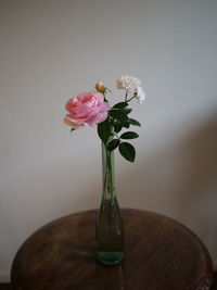 Pink and white roses in an antique bin.