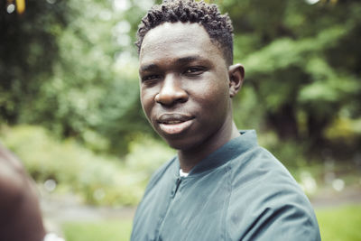 Young african man in park. fall or spring season